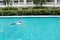 Side view image of happy elderly caucasian swimming in pool during retirement holiday with relaxation and smiling