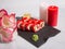Side view of Japanese sushi roll with salmon, avocado, cucumber and flying fish roe on top. rose petals and candles near served