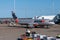 Side view of Jetstar Airbus A320 airliner taxiing to terminal gate on tarmac at Brisbane airport plane ready for unloading and