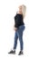 Side view of joyful carefree mid age casual woman in jeans posing and looking up