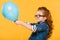 side view of kid in eyeglasses with balloon in hands