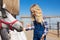 side view of kid feeding white horse