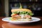 side view of layered fish sandwich with tartar sauce and lettuce