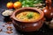 a side view of lentil soup served in a rustic clay bowl