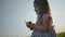 Side view of little girl in blows soap bubbles on the nature