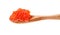 Side view of little wooden spoon with red caviar