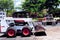 Side view of loader & rear view of flatbed trailer