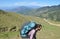 Side view of a male tourist carrying parachute backpack, walking in beautiful mountain of Himachal Pradesh