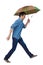 Side view of a man balancing with an umbrella