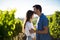 Side view of man kissing girlfriend forehead at vineyard