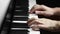 Side view of a man musician is playing piano and teach student online. Closed up to the piano key