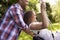 Side View Of Man Pushing Woman On Tire Swing In Garden