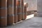 Side view of many old brown paper buckets for reuse on concrete floor in storage area