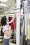 Side view of mid adult woman looking at clothing rack