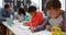 Side view of Mixed-race schoolkids drawing in the classroom 4k