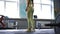 Side view motivated fit sportswoman squatting in gym working out. Confident focused Caucasian woman exercising training