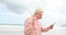 Side view of old caucasian senior man using digital tablet at beach 4k
