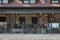 Side view of old western houses with rusty wheels doors and stone wall