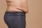 Side view of overweighted female with flabby thick stomach wearing leggings. Body positive. Violation of cell elasticity