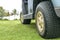 Side view of a parked green golf cart on golf course