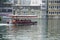 Side view of Passenger transportation with boat, water taxi trip. People wearing life jackets traveling in public ferry boat.