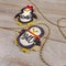 Side view of personalized Christmas penguins as decorated sugar cookies  with generic names written in frosting