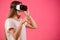 Side view photo of Caucasian female in vr headset pointing a finger