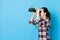 Side view photo of happy girl playing telescope