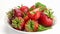 Side view pile of ripe strawberries with leaves in white ceramic dish turning.