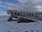 Side view of plane wreck of a DC-3 airplane on Solheimasandur beach on the southern coast in winter with sparse landscape.