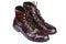 Side view of polished vintage brown leather boots on white