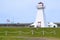 Side view of Port Borden Back Range Light at Marine Rail Park with Confederation Bridge in the background