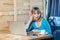 Side view portrait of attractive interesting young girl freelancer in blue blouse are sitting in cafe and making video call on