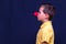 Side view Portrait of child boy wearing clown nose,red nose concept