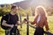 Side view portrait of couple in countryside, man giving cup of tea to girlfriend