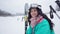 Side view portrait of happy young woman looking away admiring beauty of winter nature, turning to camera and smiling