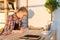 Side view portrait of interior designer writing new project, sitting at workplace. Young smart female student reading