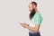 Side view portrait of shocked bald bearded man looking at mobile smart phone display with surprised face. reading good news or