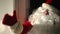 Side view positive Santa knocking in door waving inviting outdoors. Caucasian man in eyeglasses with white beard and