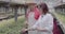 Side view of professional scientist explaining fertilizing to farmer in greenhouse. Caucasian man and woman discussing