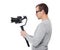 Side view of professional videographer using dslr camera on gimbal stabilizer isolated on white