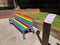 Side view of a rainbow bench in Dudelange, Luxembourg, Europe during LGBTQIA pride month on June 29 2022