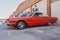 Side view of a red classic car in the street