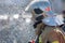 Side view of rescuer in silver mirrored helmet and protective uniform, water drops falling on firefighter Emercom of