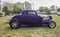 Side view of a restored purple circa 1932 vintage ford deuce coupe