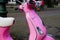 Side view on retro pink Vespa scooter parked on city square