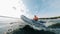 Side view of a rubber boat with a man sailing along the river