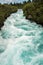 Side view of the rushing wild stream of Huka Falls near Lake Tau