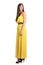 Side view of scared fashion model in yellow evening dress looking behind over her shoulder
