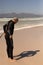 Side view of senior male surfer wearing wet suit on the beach